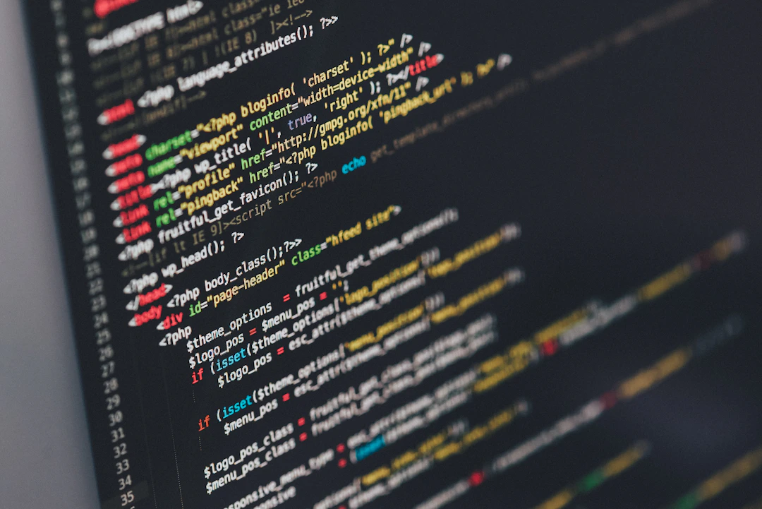Coding on laptop with colorful syntax highlighting