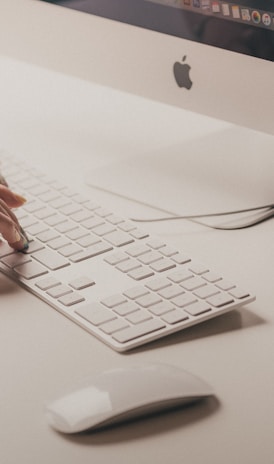 person typing on Apple keyboard