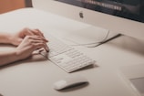 person typing on Apple keyboard