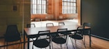 Meeting room with glass walls and a large conference table.