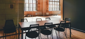 rectangular brown wooden dining table and black steel chairs