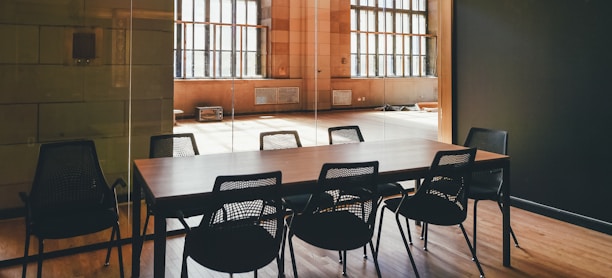 rectangular brown wooden dining table and black steel chairs