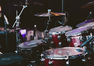 selective focus photography of red drum set