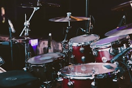 selective focus photography of red drum set
