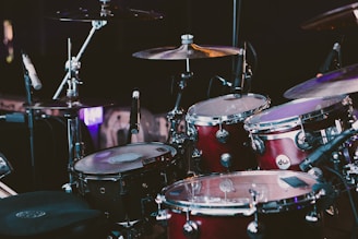 selective focus photography of red drum set