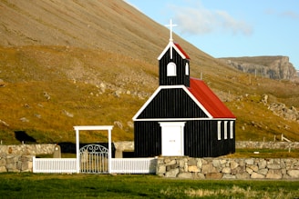 black and red church near mountain ranges