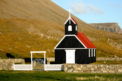 black and red church near mountain ranges