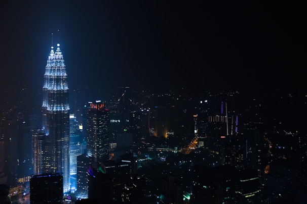 A nighttime cityscape highlighting a completed Baybars Yapı skyscraper illuminated against the dark sky.