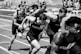 A focused athlete training intensely on a track, showcasing determination and strength.
