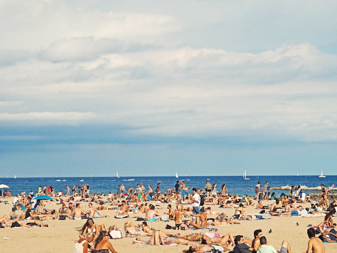 people on brown sand beach, Crowded Barcelona beach