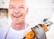 man holding orange angle grinder
