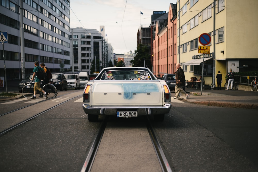 white Ford car on road