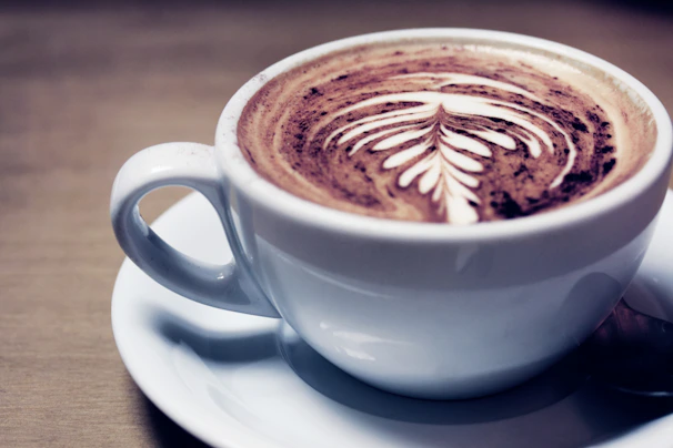 Close-up of a terracotta espresso cup resting on a linen napkin, warm and inviting.