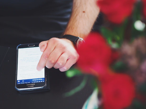 Close-up of a hand scrolling through dynamic review links on a smartphone.