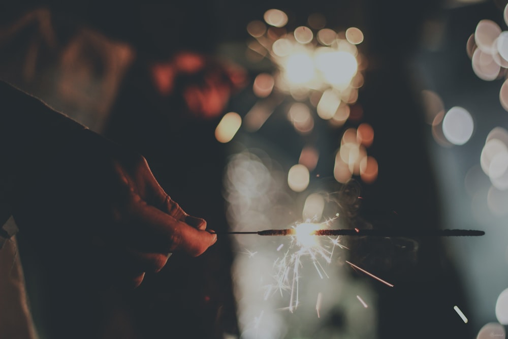 a person holding a sparkler in their hand