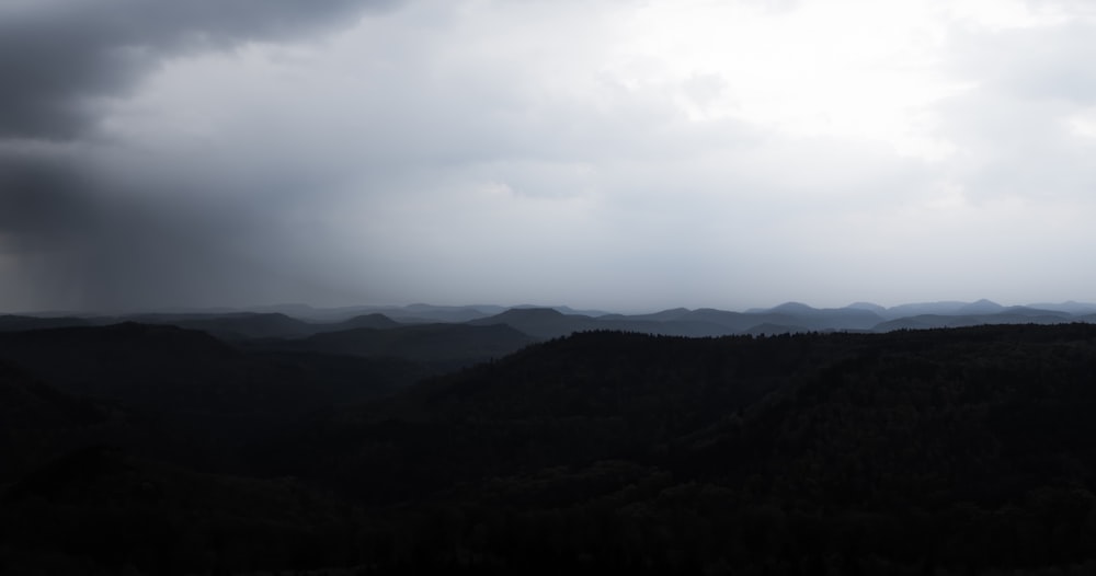 silhouette of mountain under white clouds