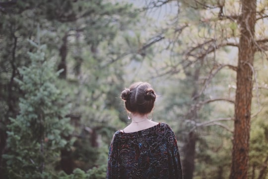 woman standing facing green forest in Boulder United States