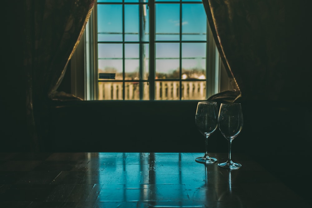 clear wine glass on blue table