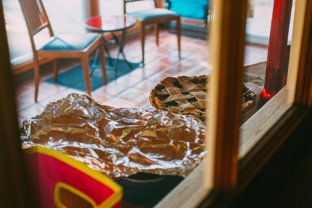 A brown and white snake rests on a wooden table, unrelated to church sign-ups or volunteer coordination.