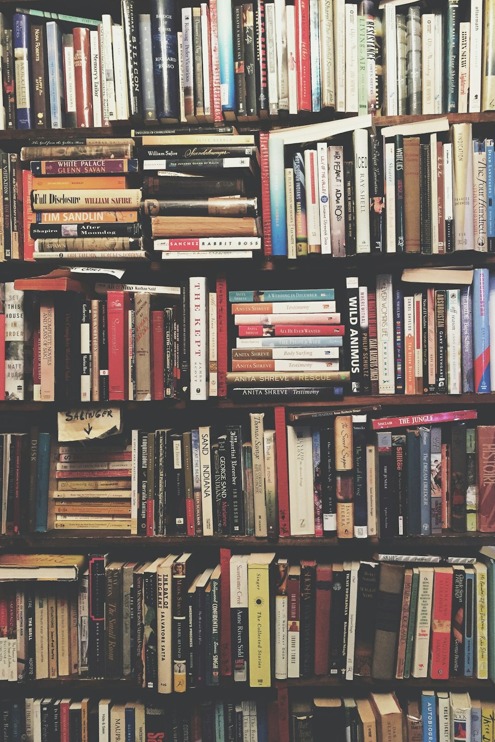 books on brown wooden shelf