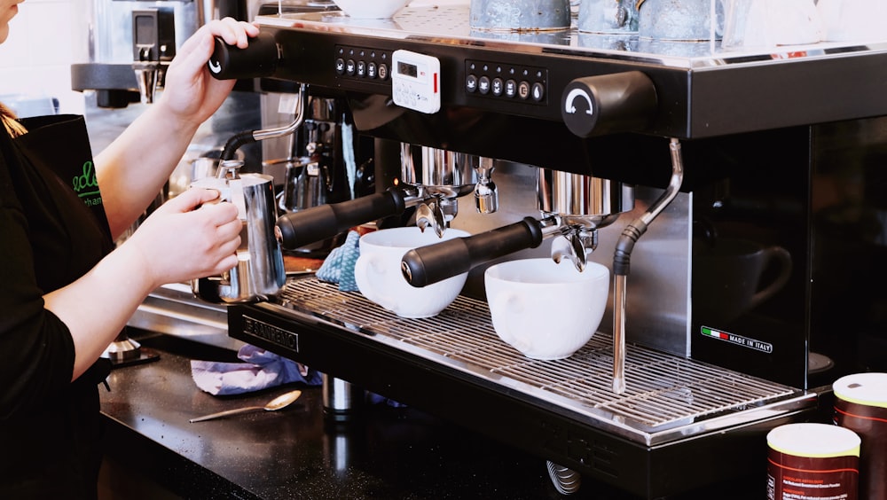 person holding black espresso maker