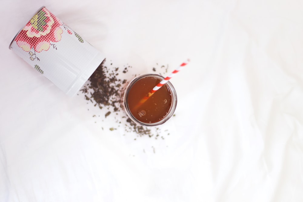 brown liquid with red and white straw