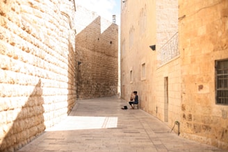 Amy capturing a candid moment of street musicians playing fado in a cozy Lisbon alley.