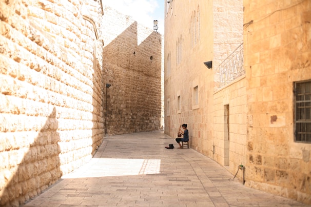 Amy capturing a candid moment of street musicians playing fado in a cozy Lisbon alley.