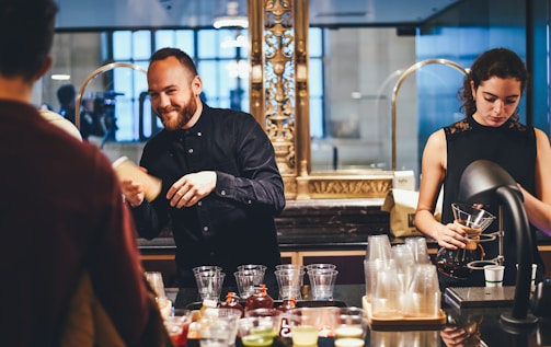 Bartenders preparing drinks representing premium hospitality service standards.