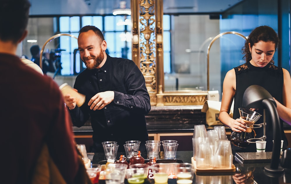 photo of man and woman mixing beverages