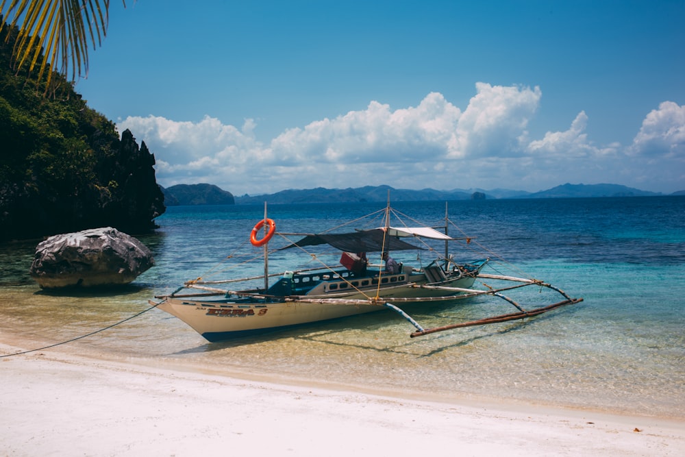 boat near seashore during daytime