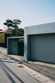 Wide shot of a concrete driveway completed by b&b concrete contractors, surrounded by a neat suburban home.