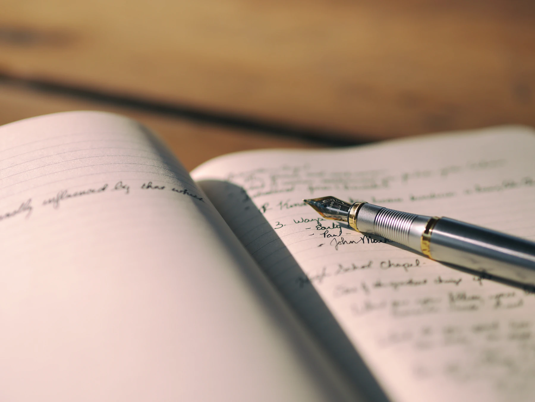 A handwritten journal with a fountain pen