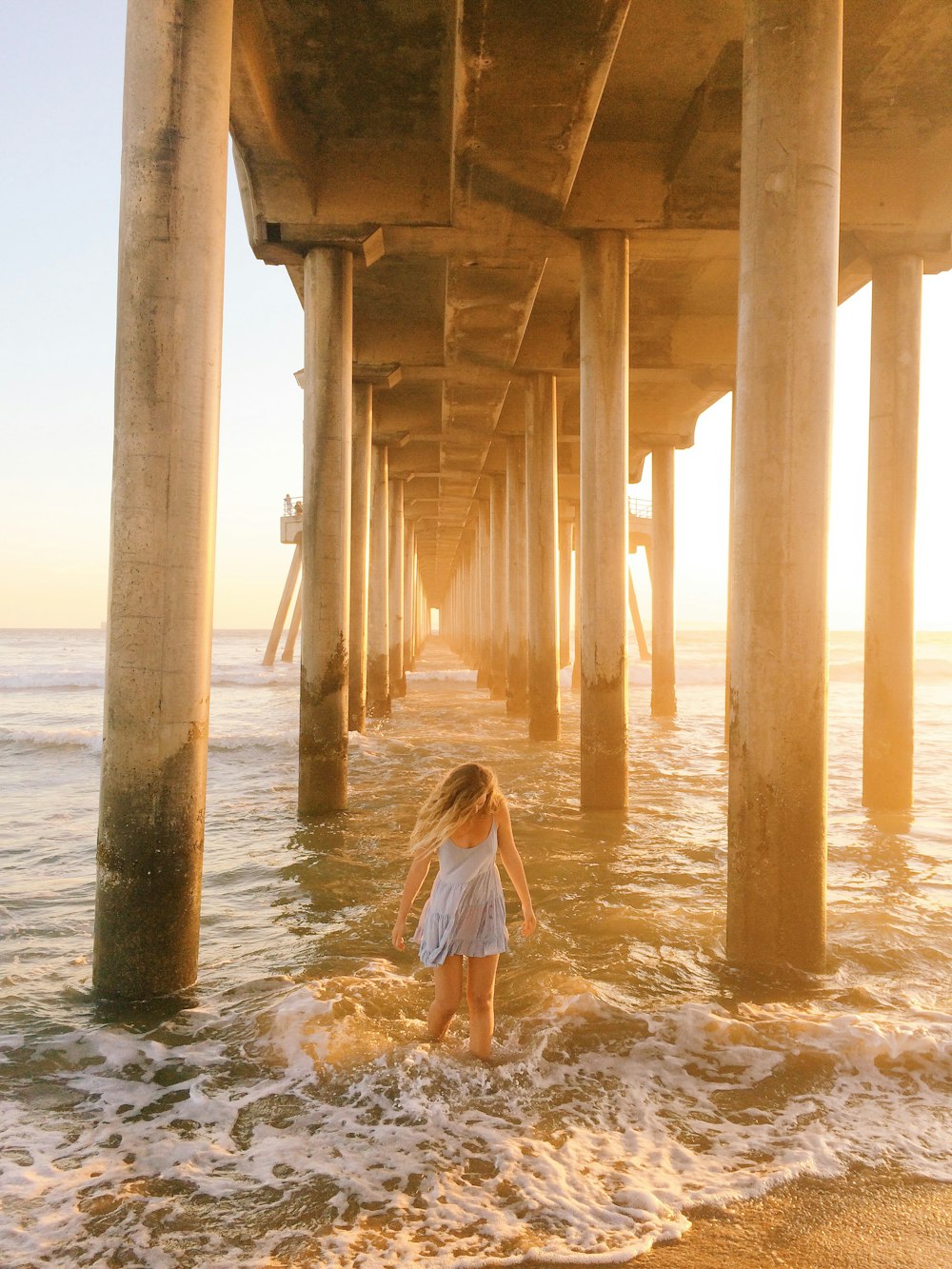 woman walking under dock