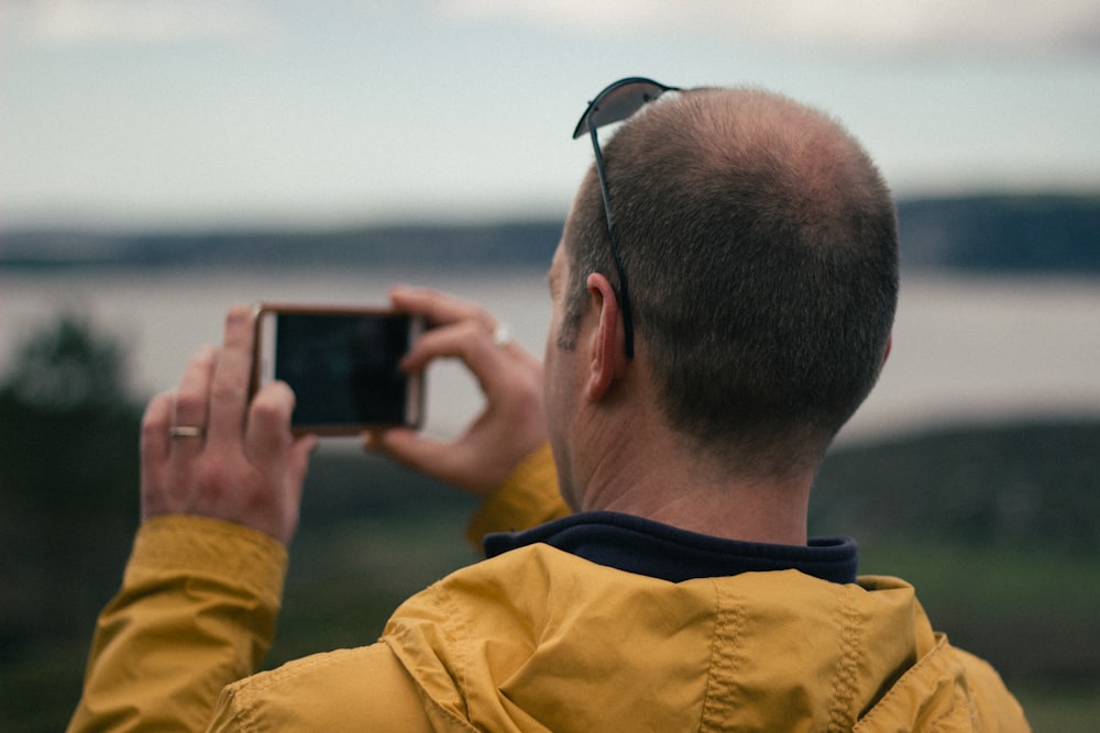 man taking picture of nature