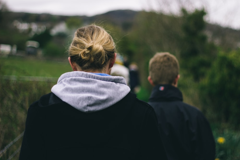 photo of two person walking during daytime