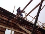 Workers practicing safety harness use during height training