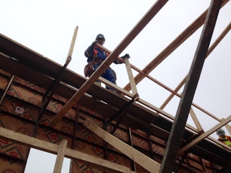 A worker demonstrating the use of safety harness equipment.
