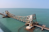 brown wooden dock on blue sea under blue sky during daytime