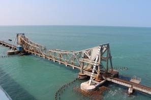 brown wooden dock on blue sea under blue sky during daytime