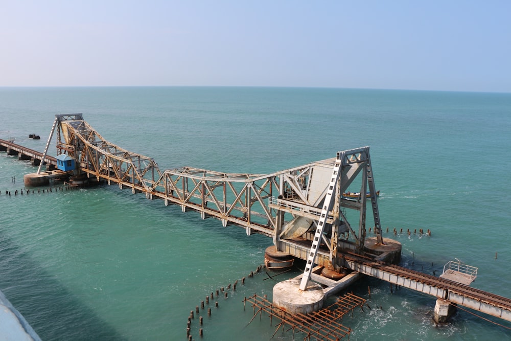 brown wooden dock on blue sea under blue sky during daytime