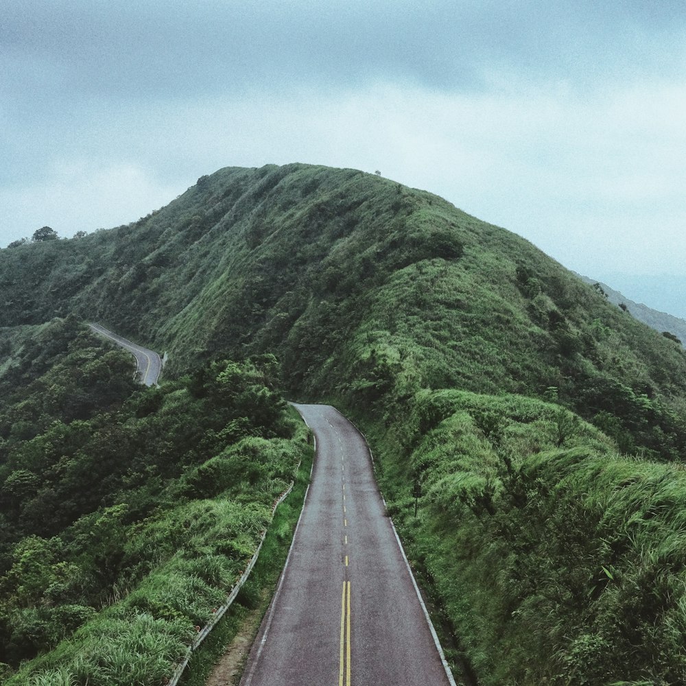 photo of road between mountain