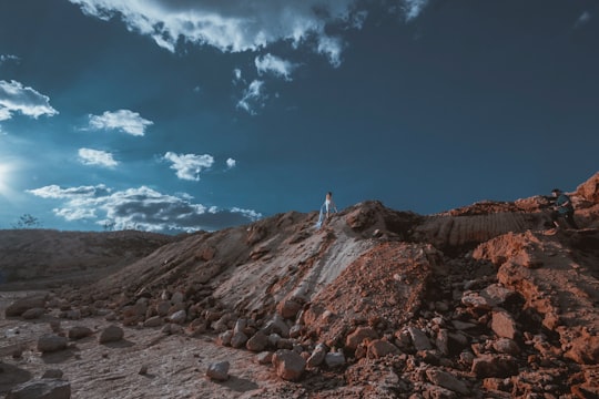 person standing on tops of rock formation during daytime in Morelia Mexico