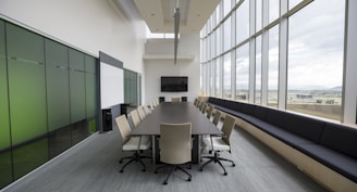 rectangular brown wooden table with chair lot inside building