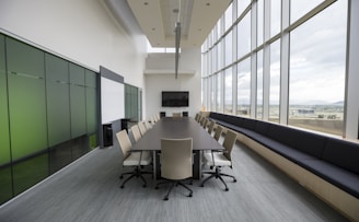 rectangular brown wooden table with chair lot inside building