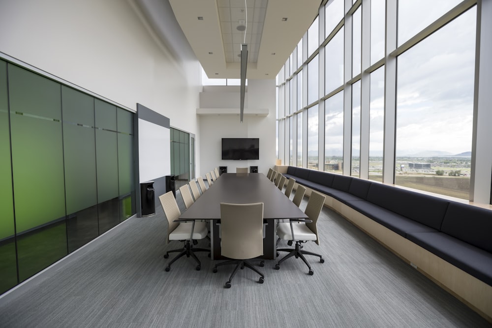 rectangular brown wooden table with chair lot inside building