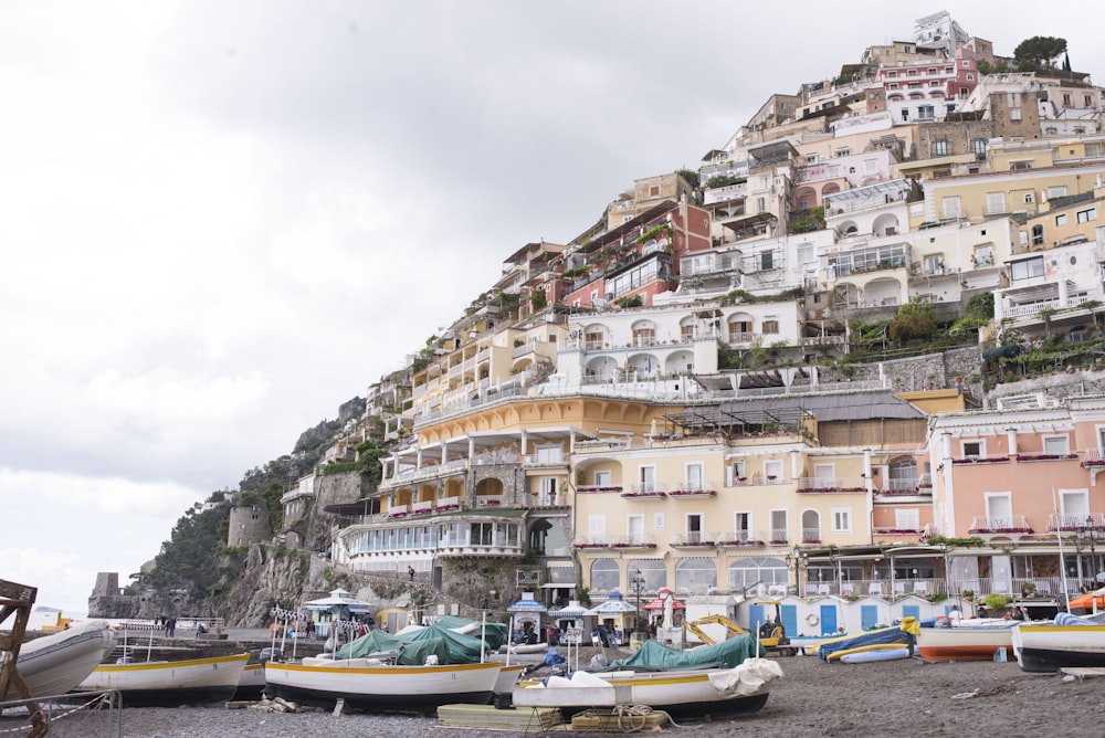 assorted sail boats on seashore during daytime