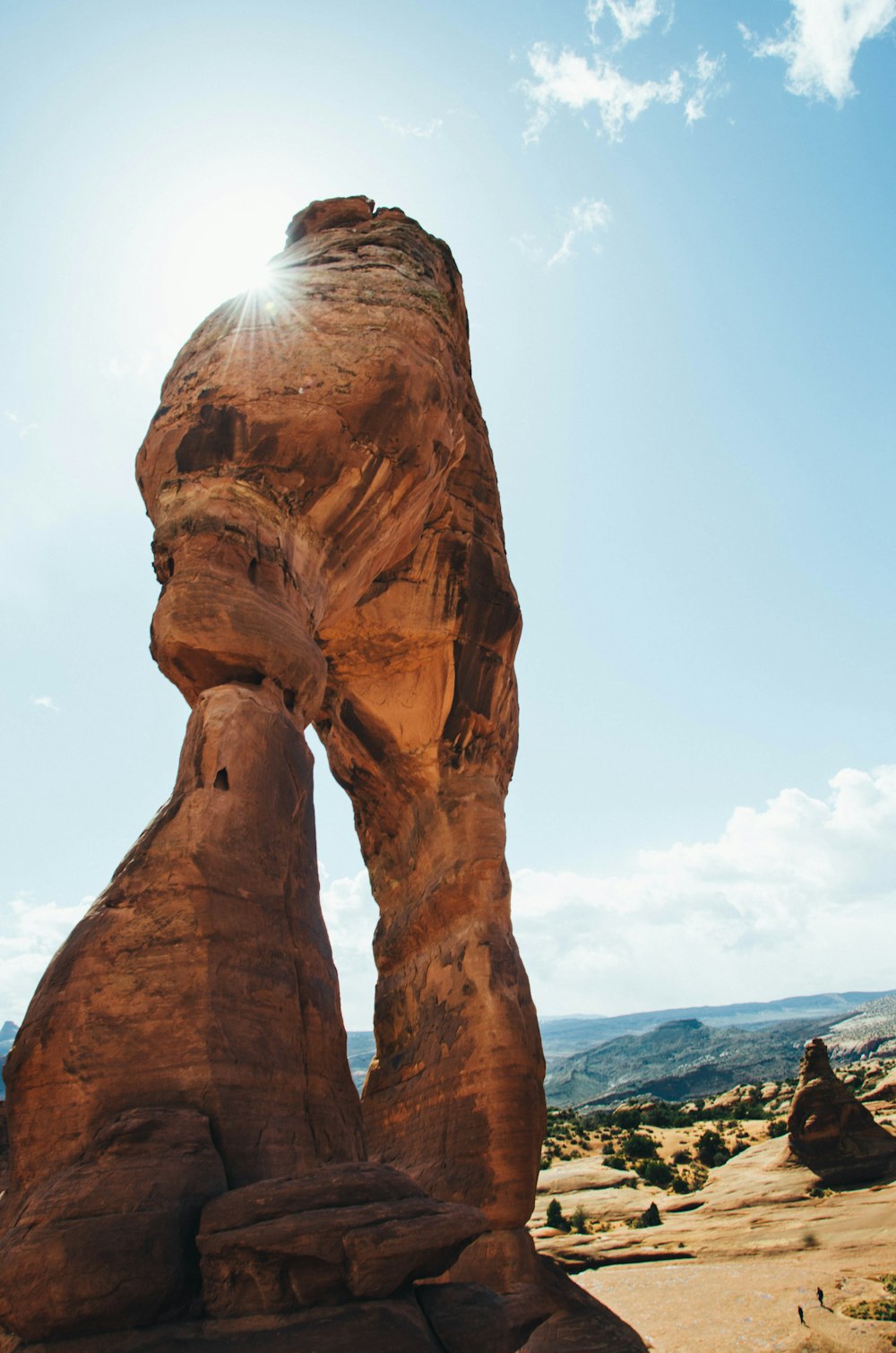 brown boulder near canyon under blue sky