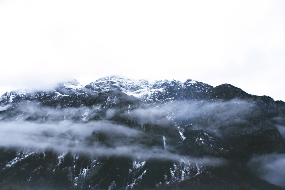 a view of a mountain covered in clouds