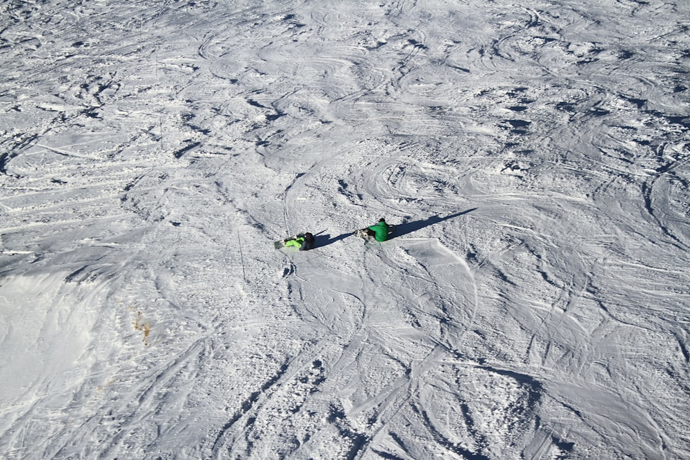 person sitting on snow covered field